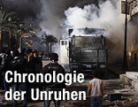 Menschen stehen vor einem brennenden Lkw