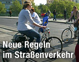 Radfahrer &uuml;berqueren eine Kreuzung in Wien