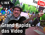 Mann singt und spielt Gitarre