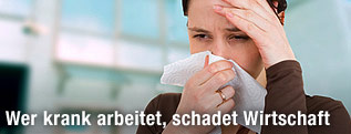 Frau h&auml;lt sich Taschentuch vor die Nase und mit der anderen Hand die Stirn