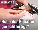 Person nimmt einen Zehn-Euro-Schein aus einem Geldbörsel