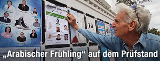 Mann vor Wahlplakaten in Tunis
