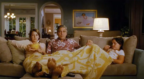 © 2011 Twentieth Century Fox George Clooney als Matt King sitzt mit seinen Töchtern auf der Couch
