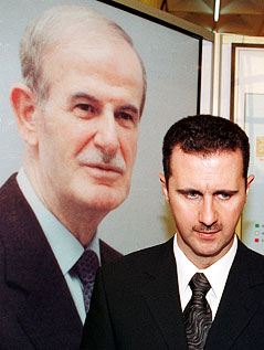 © Reuters/Khaled Al Hariri Baschar al-Assad vor einem Foto von seinem Vater Hafis al-Assad