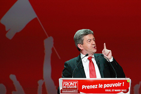 Jean-Luc Melenchon mit roter Krawatte vor rotem Wahlplakat