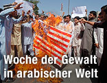 Demonstranten verbrennen eine US-Flagge