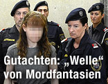 Angeklagte wird von Polizisten in den Gerichtssaal gef&uuml;hrt