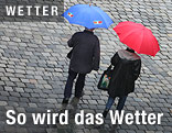 Passanten mit Regenschirmen