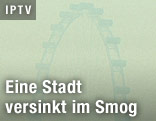 Wegen Smog kaum sichtbares Riesenrad