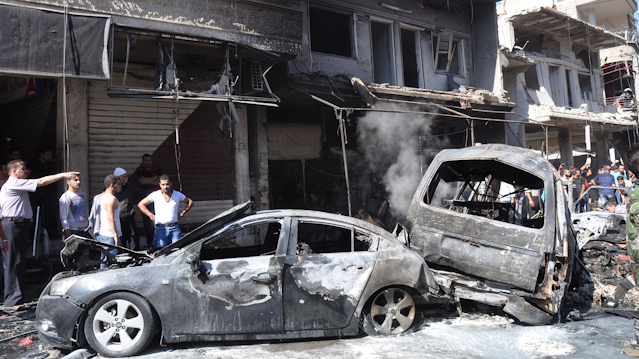 © AP/SANA Zerstörte Fahrzeuge nach Autobombe