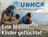 Syrische Kinder mit ihrer Mutter in einem Flüchtlingscamp im Irak