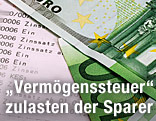 Geldscheine liegen auf Sparbuch