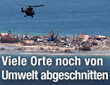 Hubschrauber über verwüsteter Landzunge