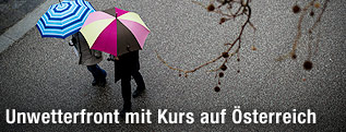 Zwei Menschen mit Regenschirm