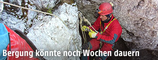 Eine Rettungskraft seilt sich ab