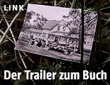 Szene vom Trailer zeigt ein Foto in einem Busch