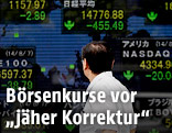 Mann vor elekronischer Tafel mit Aktien-Indizes verschiedener L&auml;nder