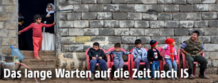 Kinder vor verfallenem Haus in Erbil