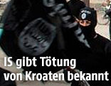 Vermummte IS-Anhänger mit Flagge