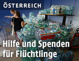 Helfer verteilen Nahrung, Getr&auml;nke und Hygieneartikel an Fl&uuml;chtlinge