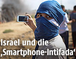 Vermummter Palästinenser mit Smartphone