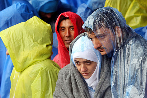 © APA/AFP Flüchtlinge im Regen