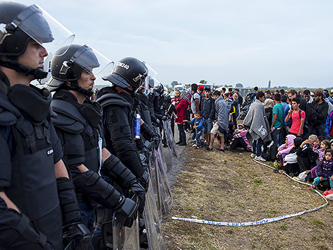 Flüchtlinge und Polizisten in Ungarn