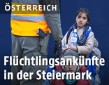 Flüchtlinge vor einem Polizisten