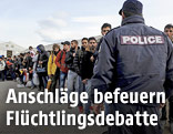 Polizist und Fl&uuml;chtlinge