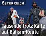 Fl&uuml;chtlinge auf einem Schotterweg