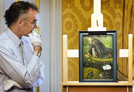 © APA/AFP/ANP/Piroschka van de Wouw Wissenschaftler zeigt das Bild "Die Versuchung des heiligen Antonius" von Hieronymus Bosch