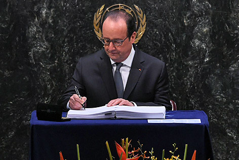 © APA/AFP/Jewel Samad Frankreichs Präsident Francois Hollande beim Unterzeichnen des Klimaschutzabkommens