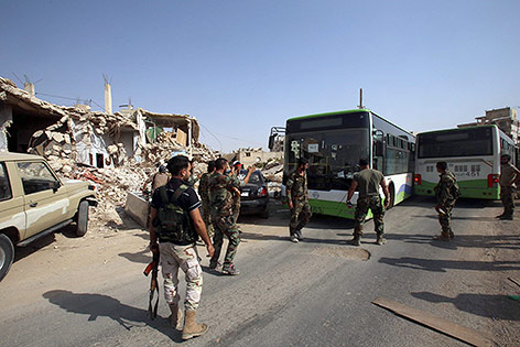 © APA/AFP/Youssef Karwashan Busse und Soldaten in Daraja