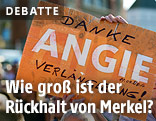 Frau hält "Danke Angie" Schild
