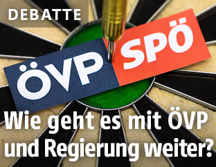 ÖVP- und SPÖ-Logo auf einer Dartscheibe