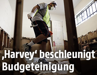 Mann geht durch beschädigtes Haus
