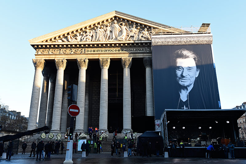 © APA/AFP/Bertrand Guay Poster von Johnny Hallyday auf der La Madeleine Kirche