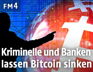 Mann zeigt auf ein Bitcoin-Logo