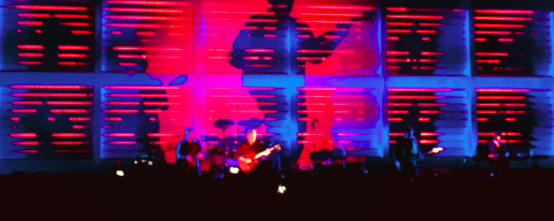 New Order Konzert mit Schattenspiel an der Bühnenwand