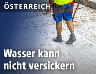 Bauarbeiter betoniert eine Stra&szlig;e